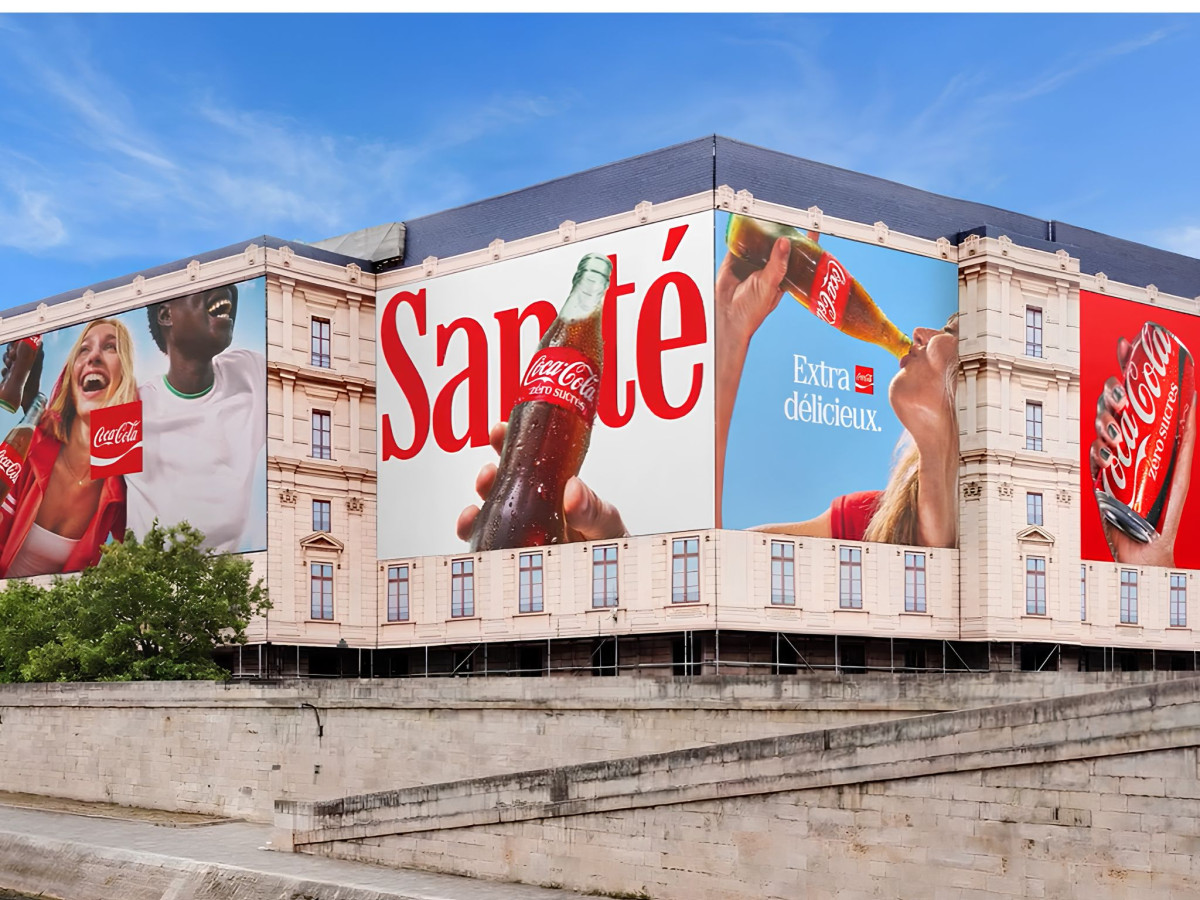 Multi-panel Coca-Cola billboard covering a building facade.