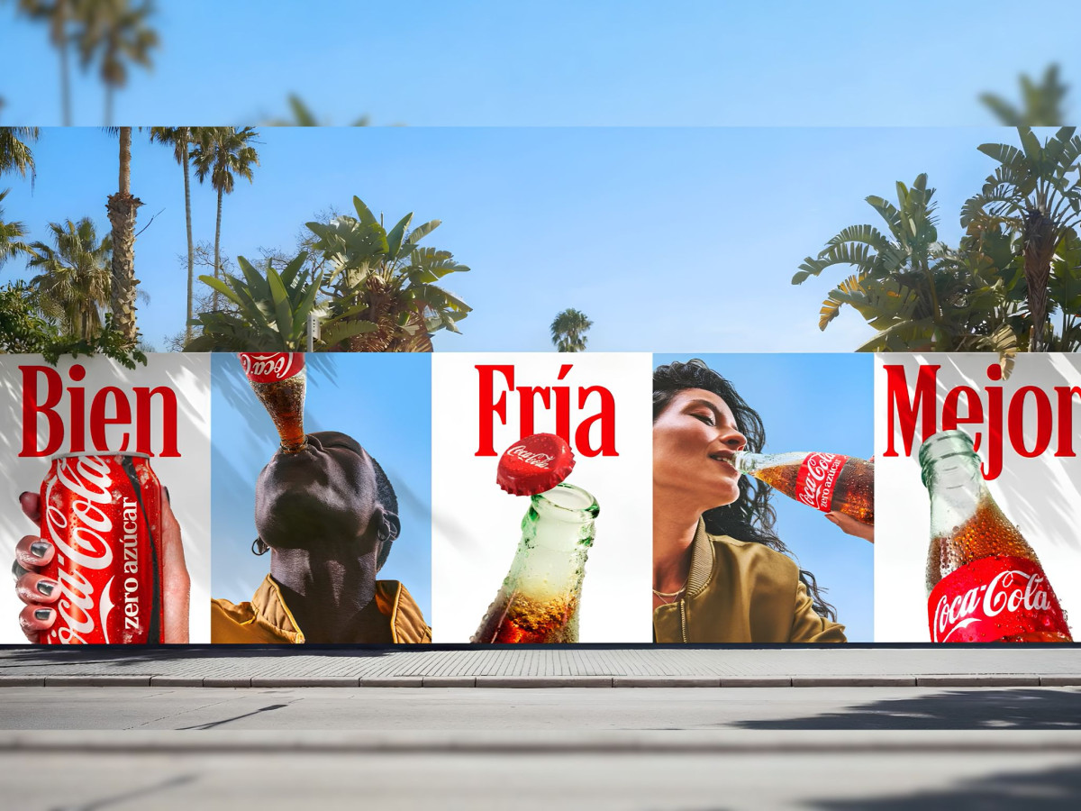 Street-level Coca-Cola billboard featuring people drinking Coke.
