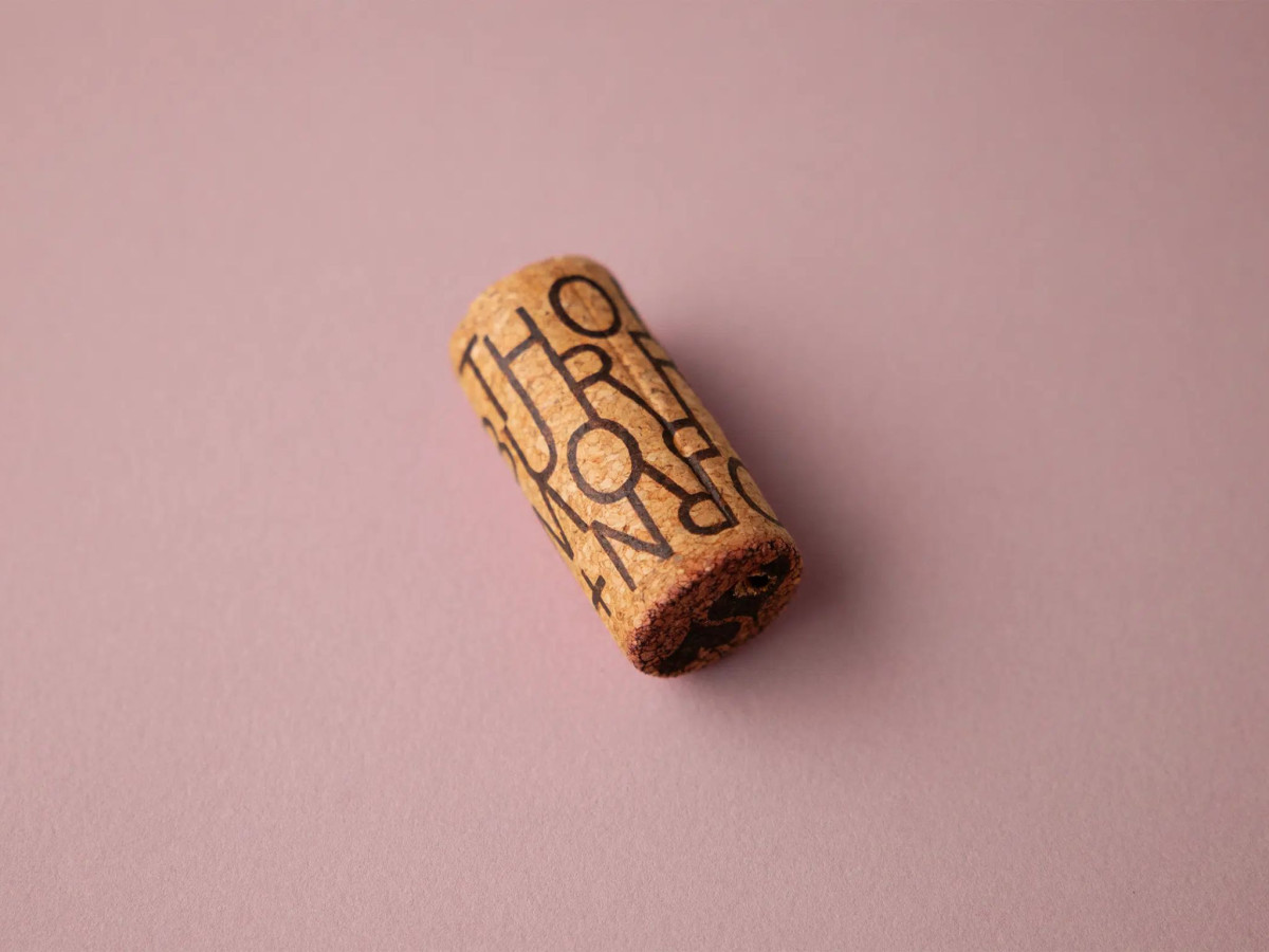 Wine cork featuring wraparound THORN + BURROW typography.