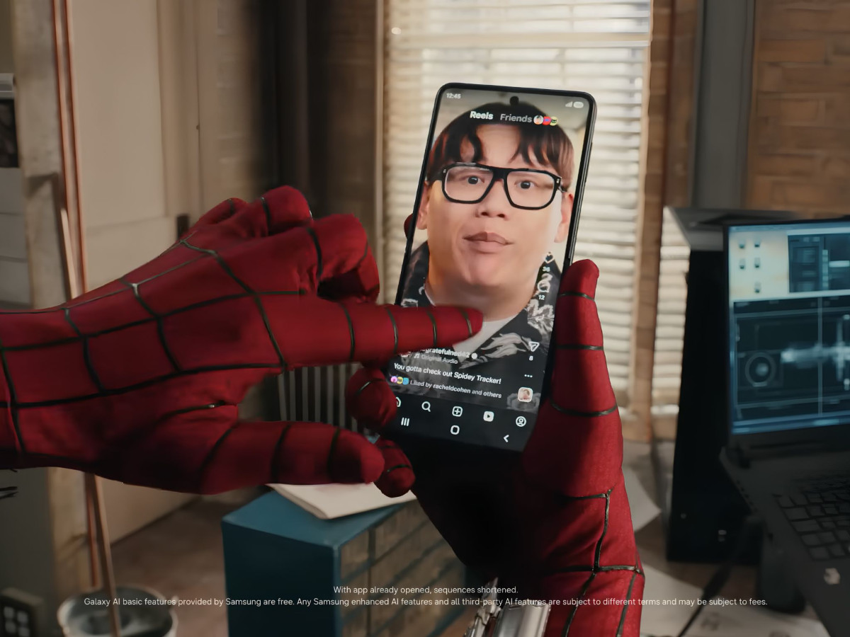 Spider-Man holding a Samsung phone displaying a video reel.