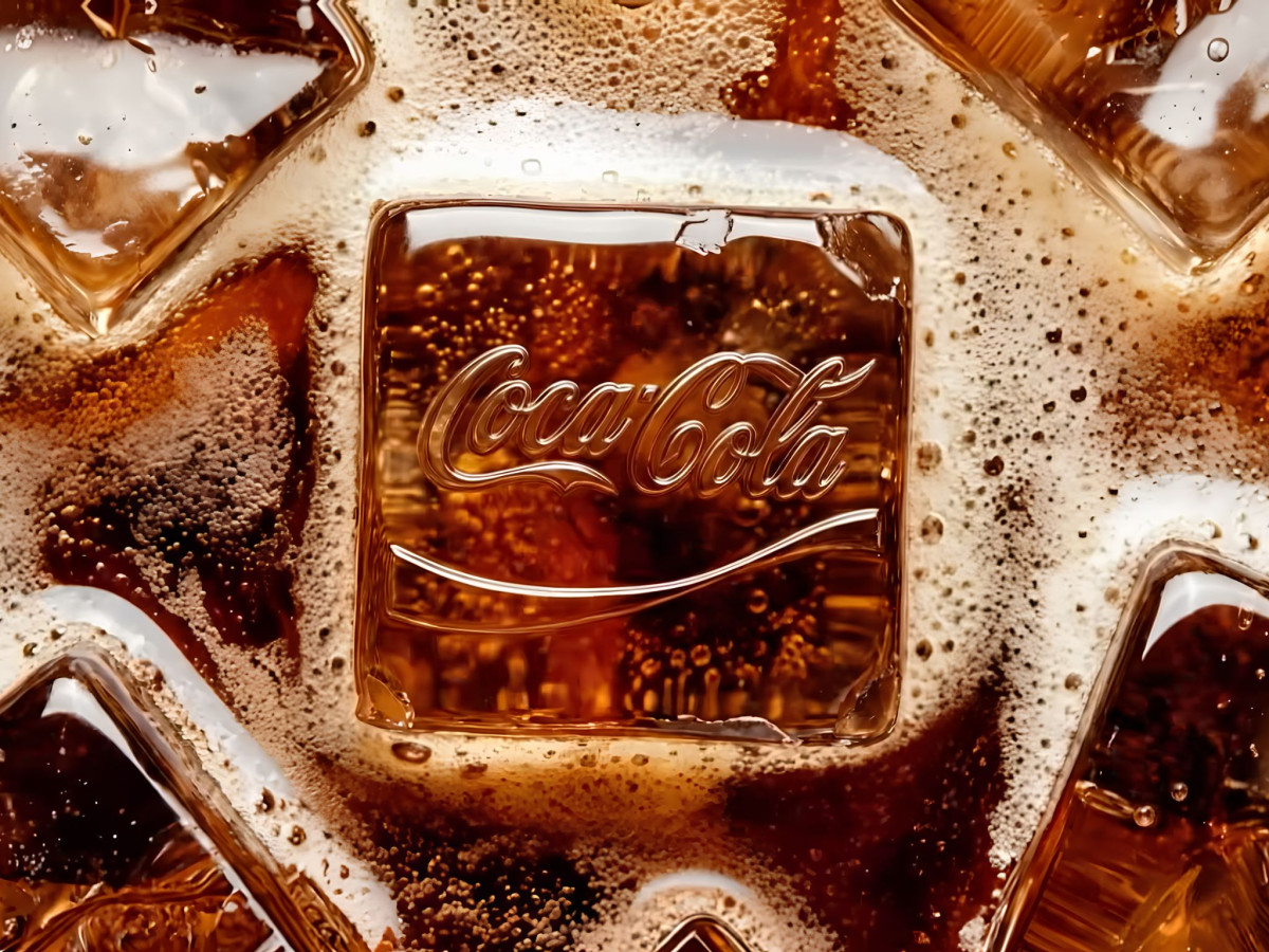 Ice cube with an embossed Coca-Cola logo in bubbly cola.