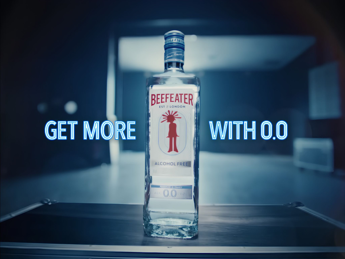 Beefeater 0.0% bottle beside neon promotional text.