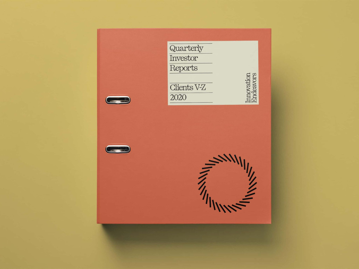 Orange binder featuring an Innovation Endeavors Quarterly Investor Reports label.