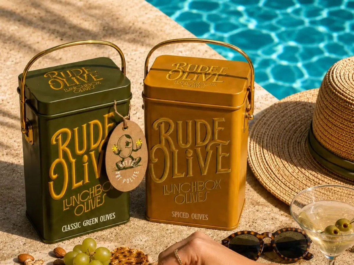 Rude Olive lunchbox tins by a swimming pool.