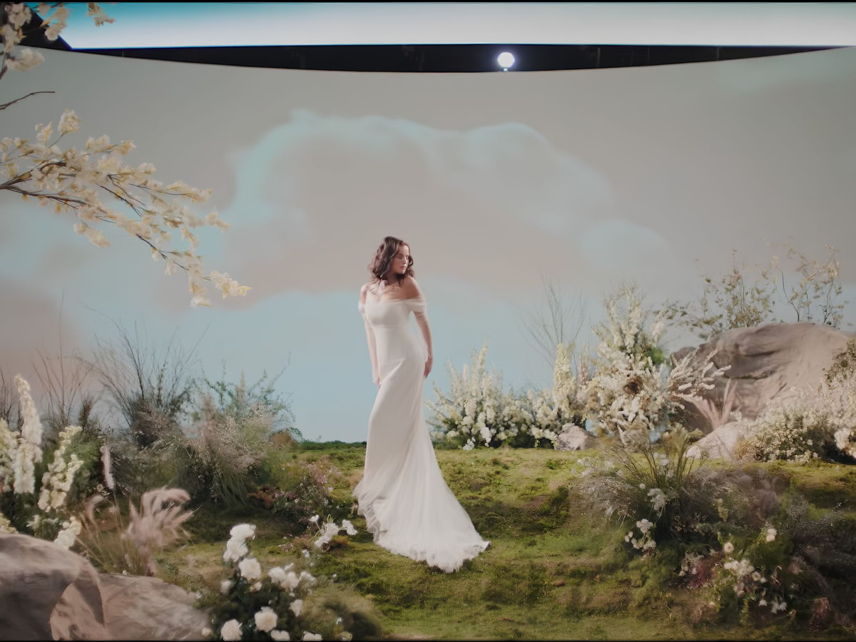 Woman in a white dress on a floral set.