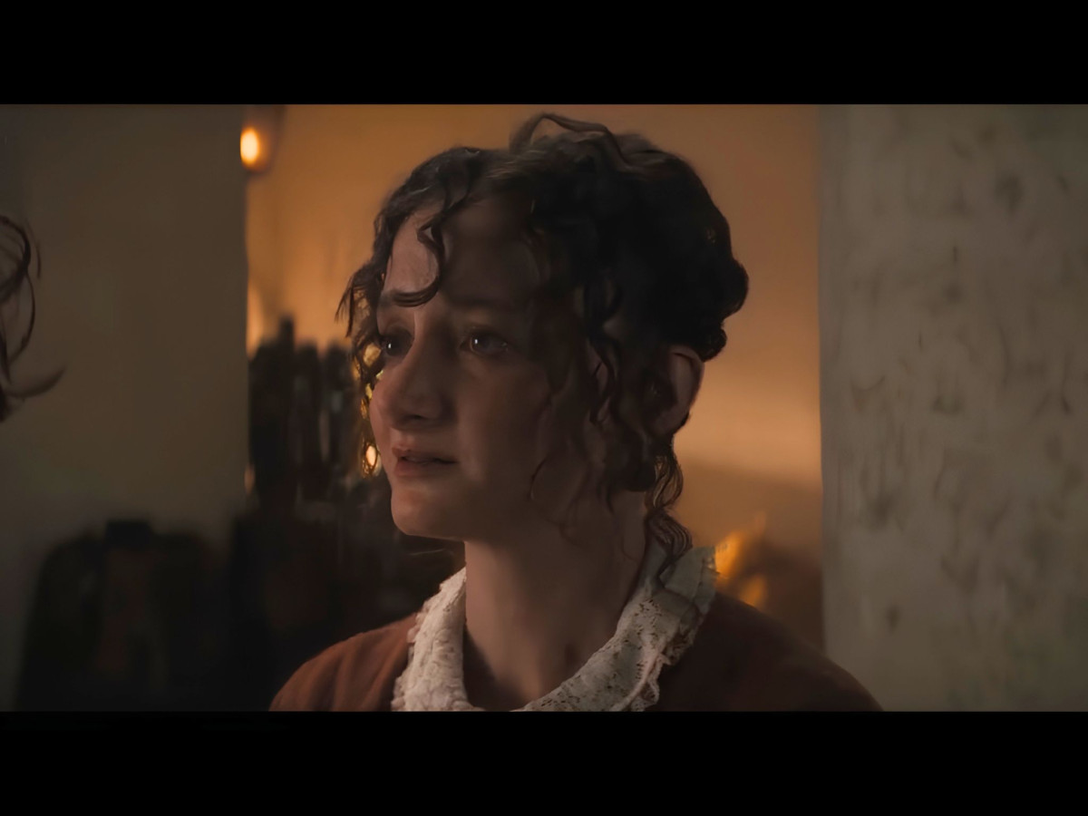 Dramatic, crying woman looking off-camera in dim lighting.