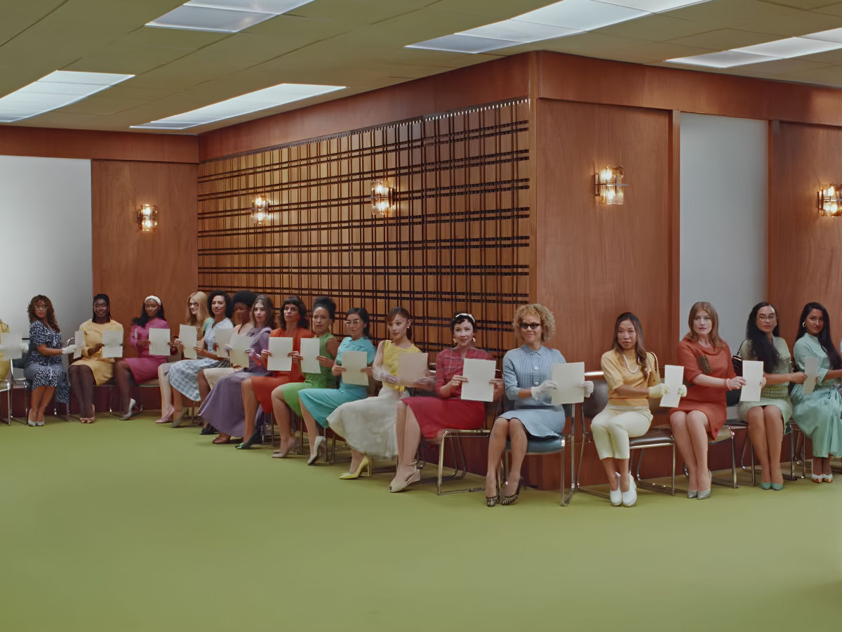 Women sitting in a waiting room holding audition papers.