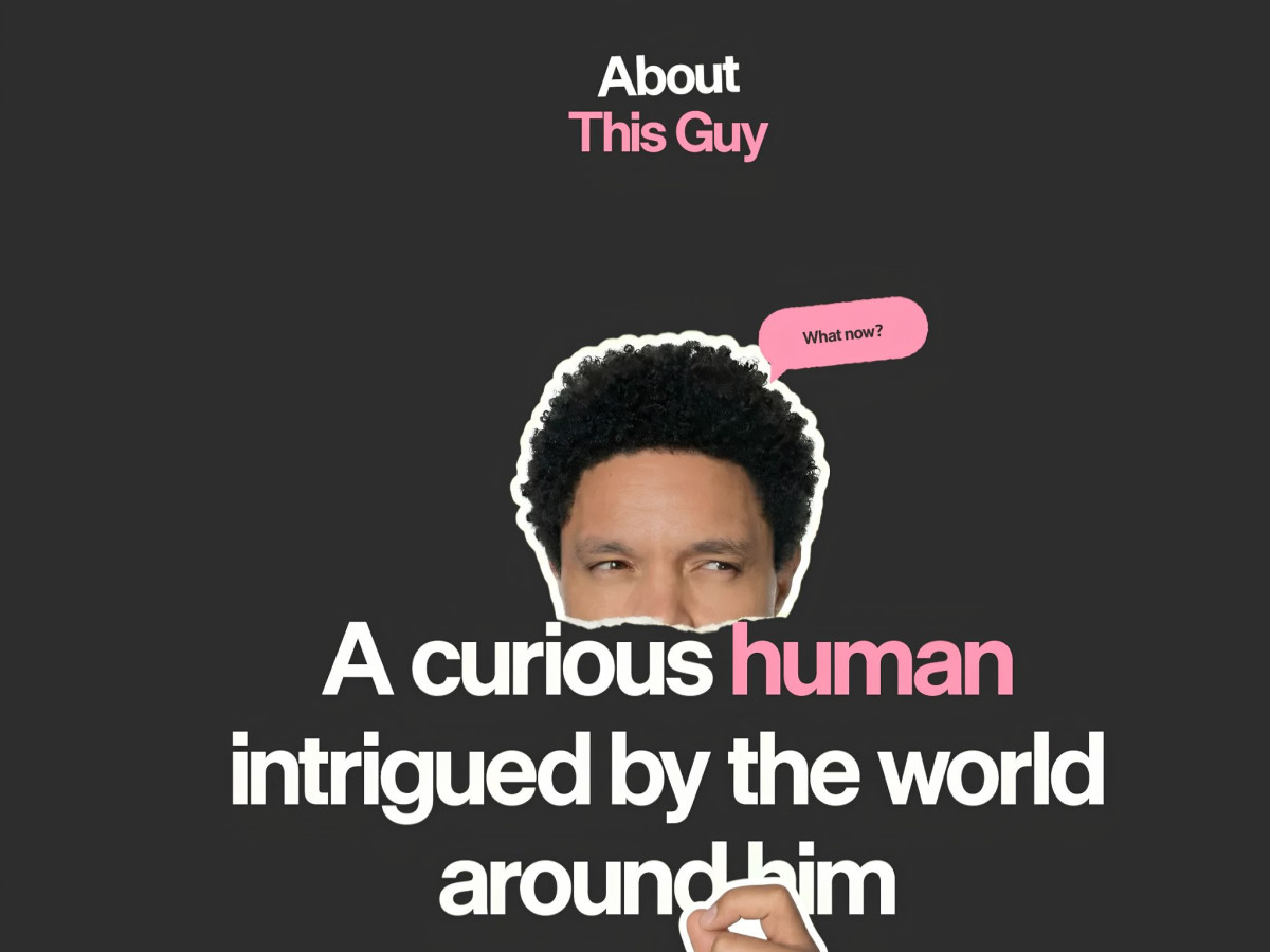 Trevor Noah head cutout peeking over large website text.