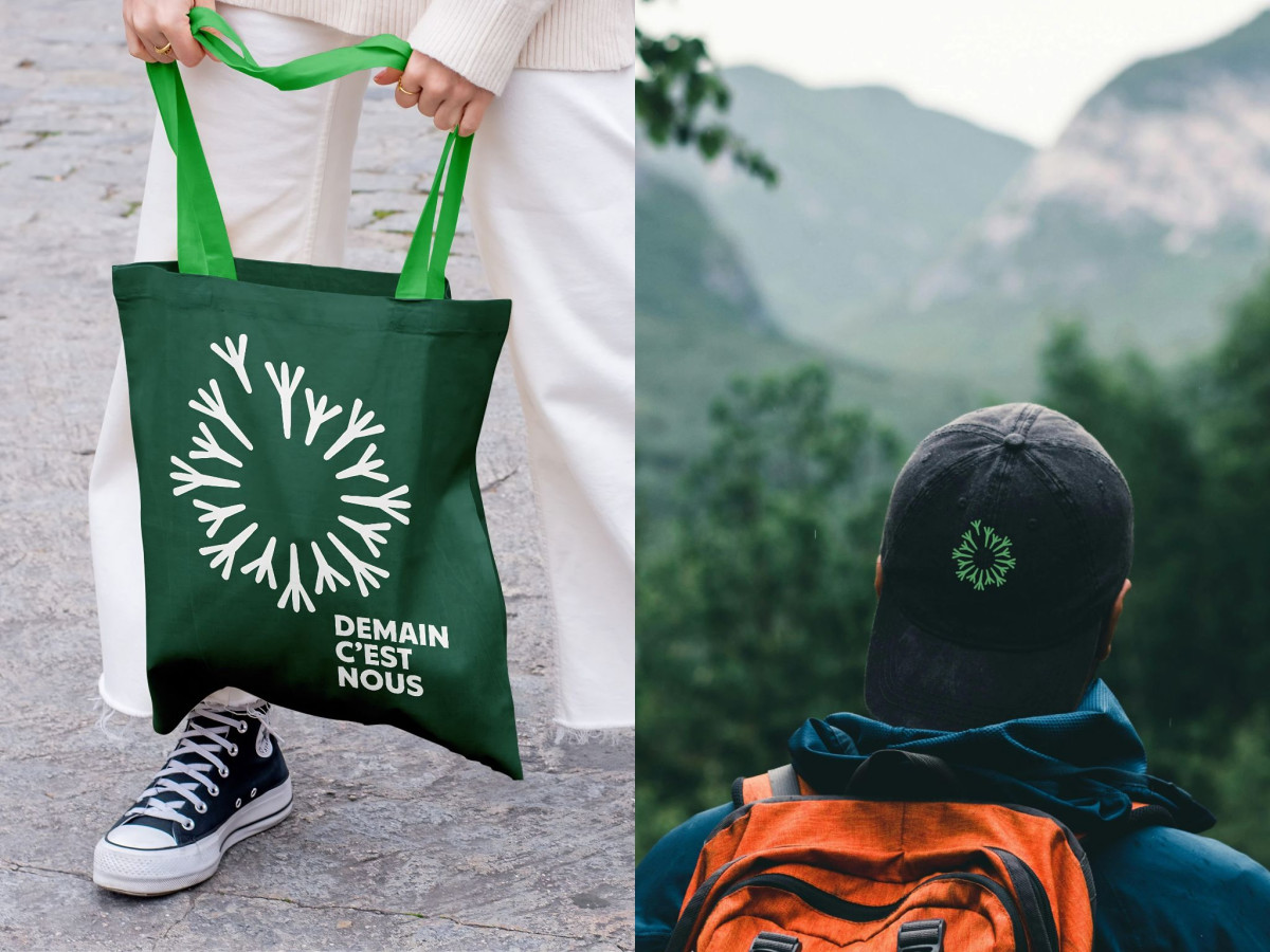 Demain C'est Nous logo on green tote and black cap.