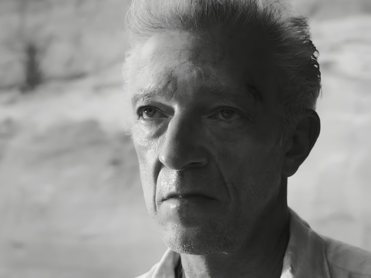 Black and white portrait of a weathered, serious man.