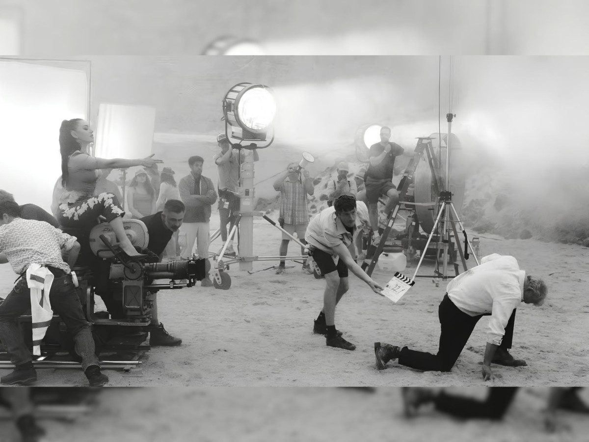 Black and white behind-the-scenes film set with crew.