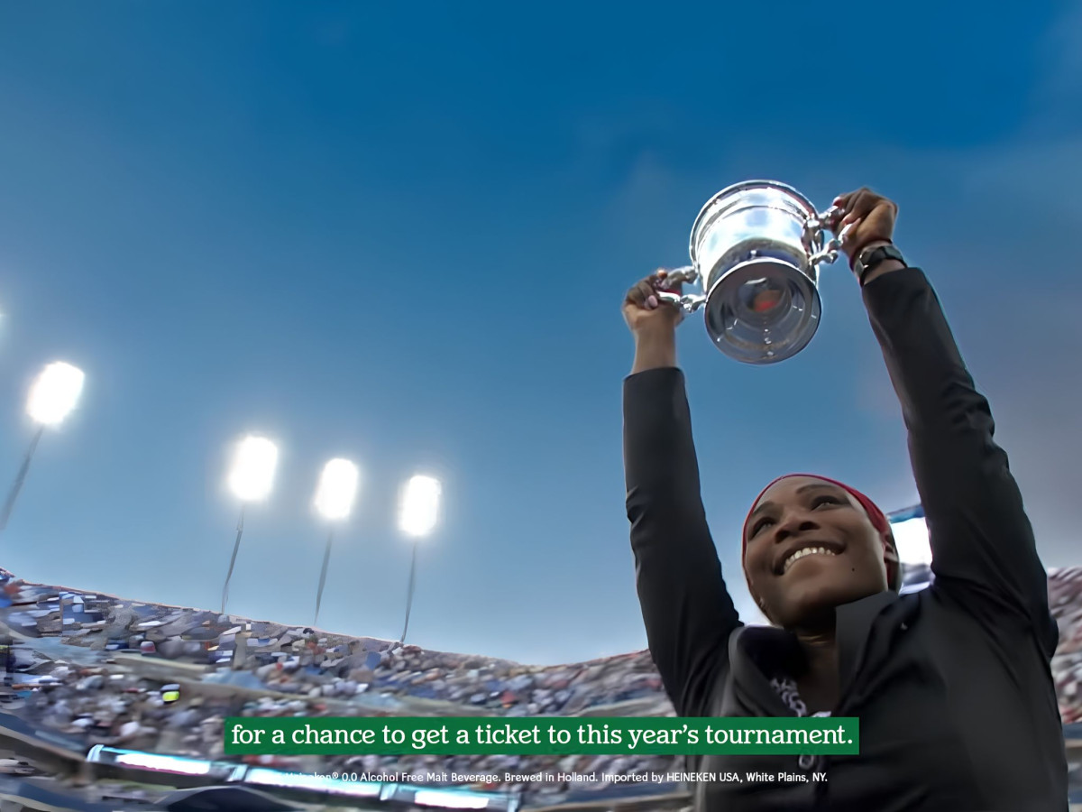 Serena Williams holding a silver trophy.