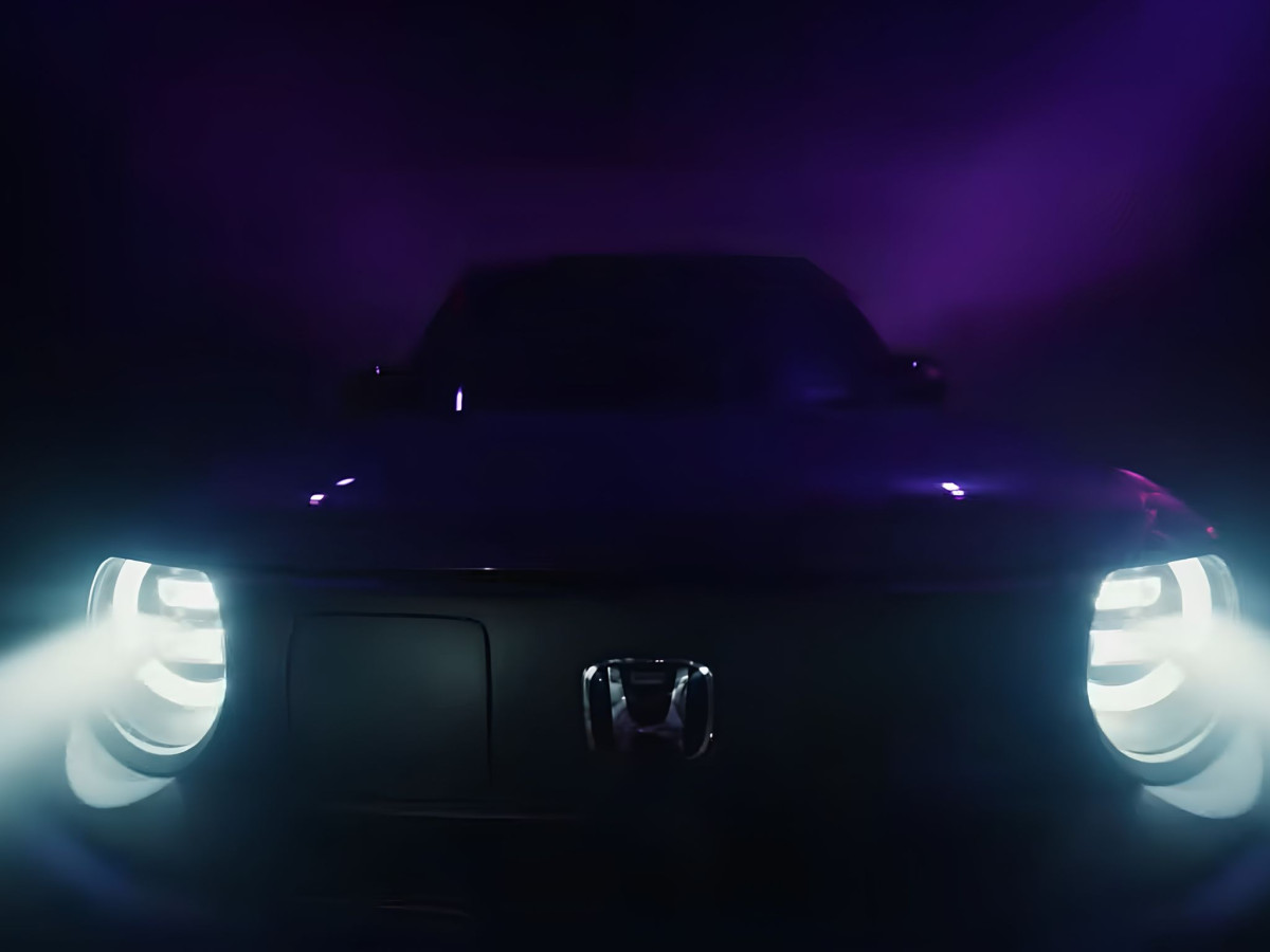 Illuminated headlights of Honda Super-N in dark mist.