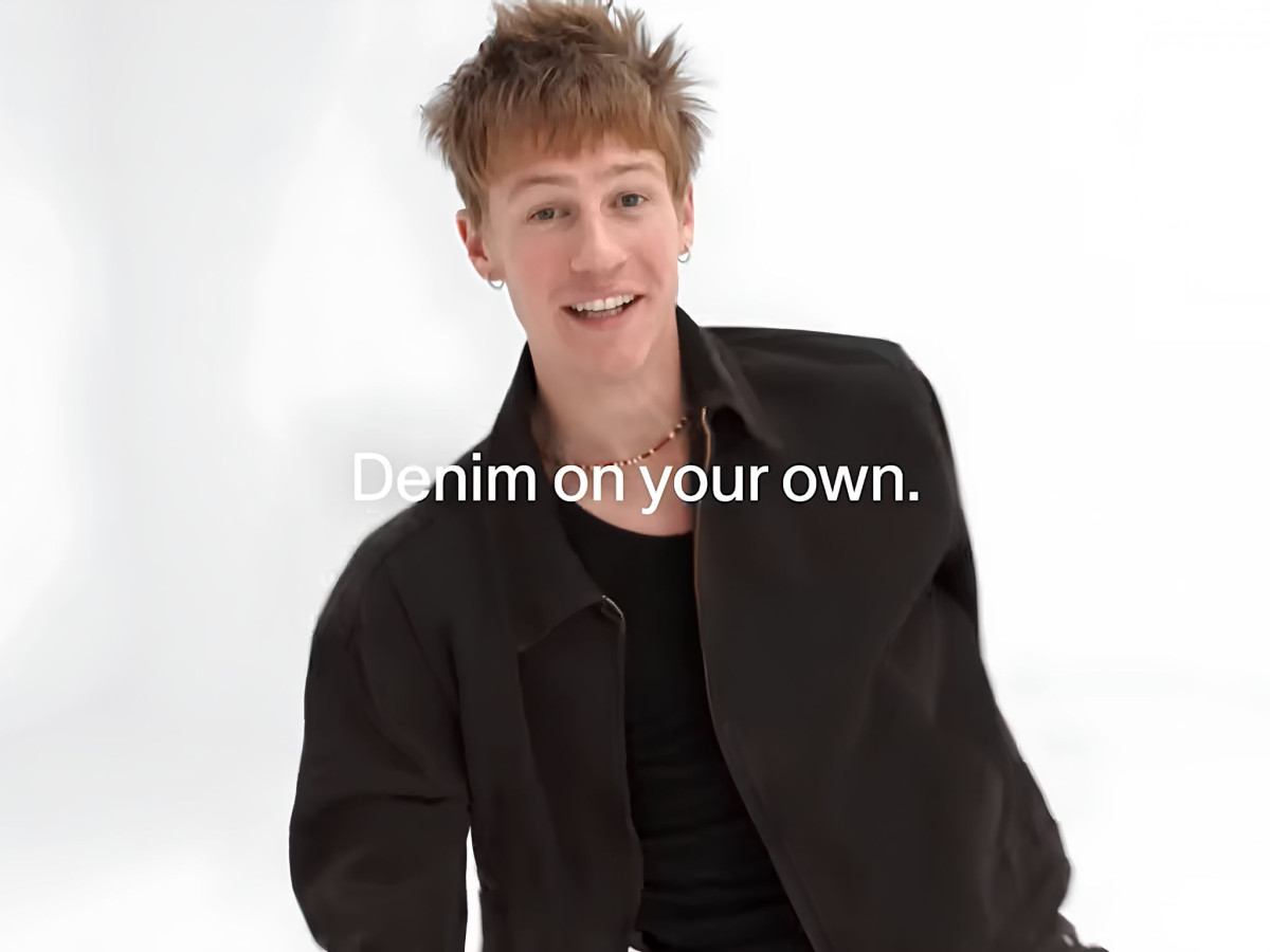 Smiling young man with "Denim on your own" text.