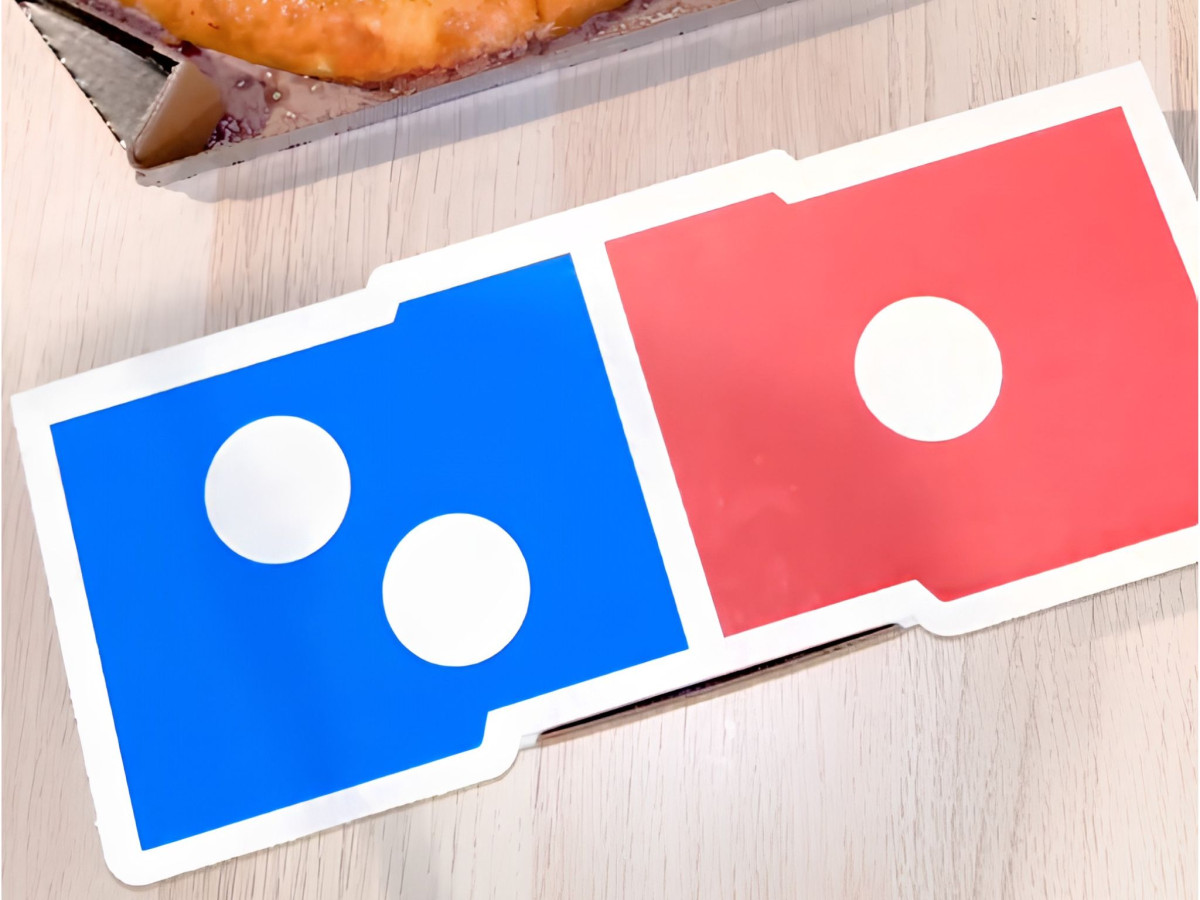 Closed rectangular Domino's pizza box resembling a domino.