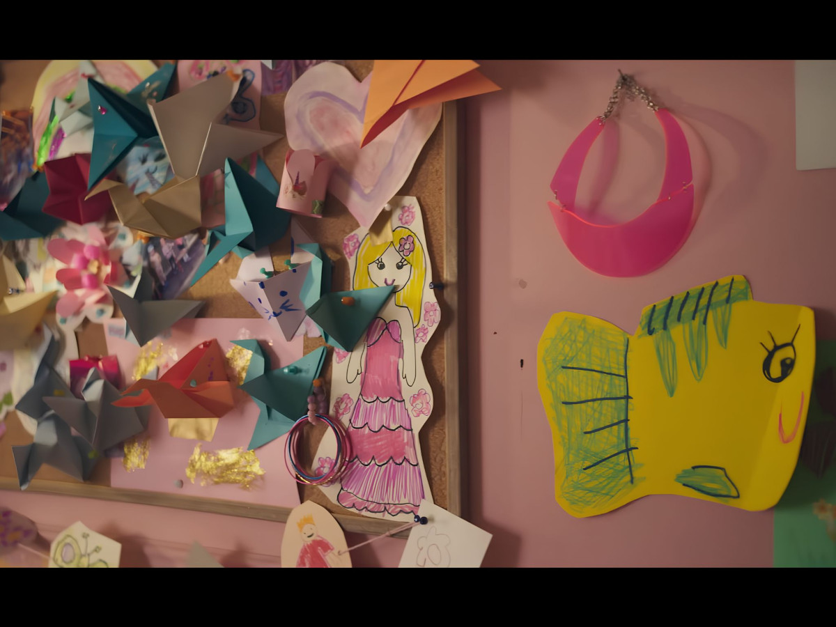 Bulletin board filled with origami and princess drawings.