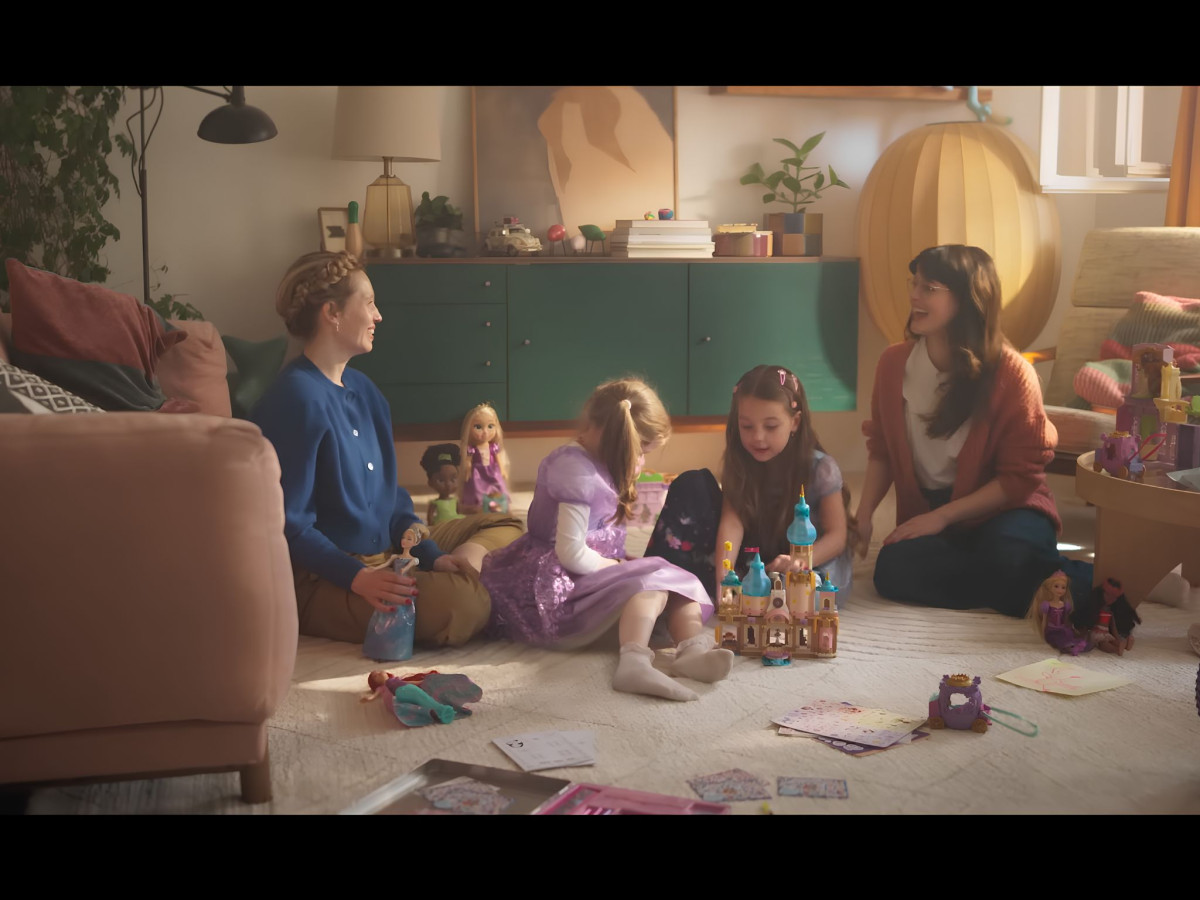 Mothers and daughters playing with Disney dolls together.