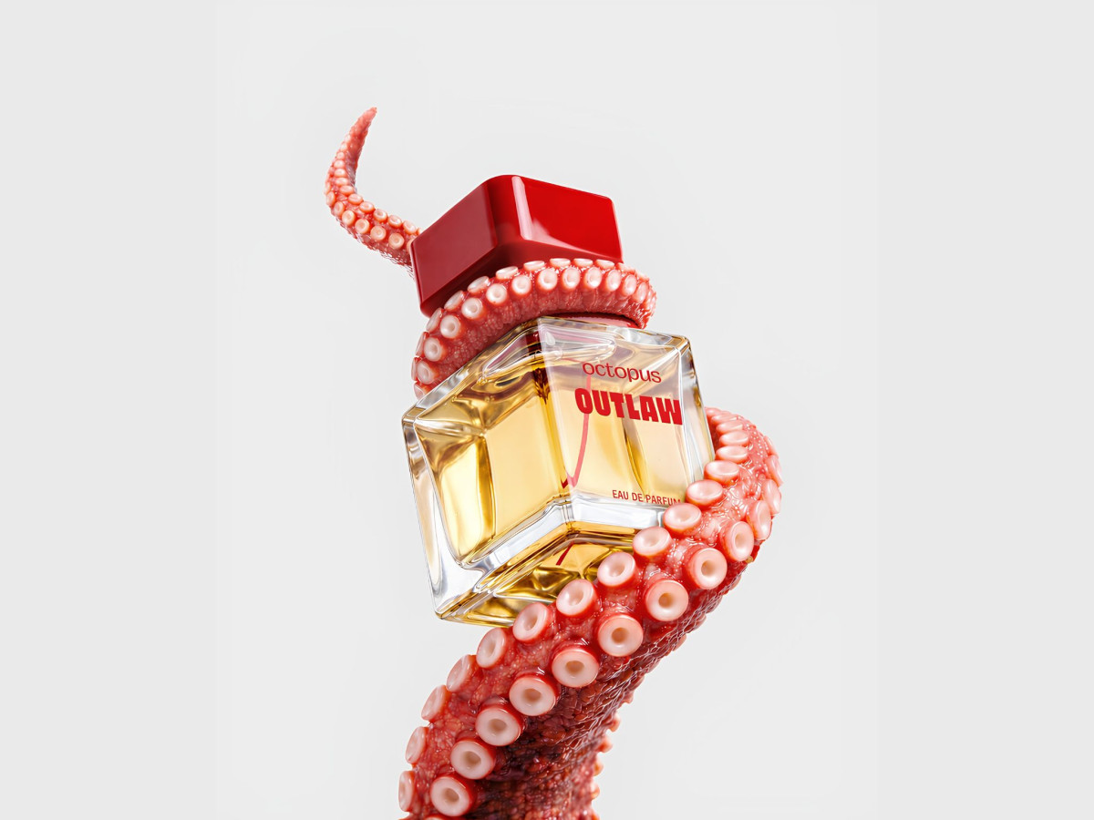 Octopus perfume bottle wrapped in a tentacle.