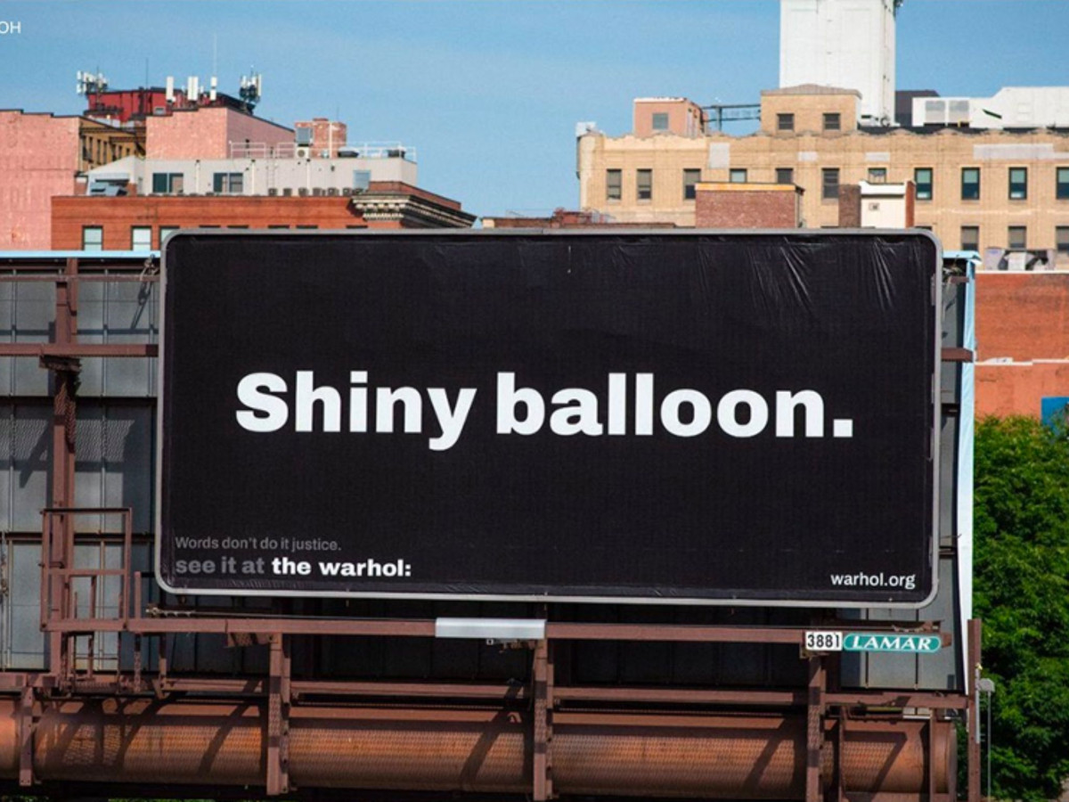 Black billboard reading "Shiny balloon."