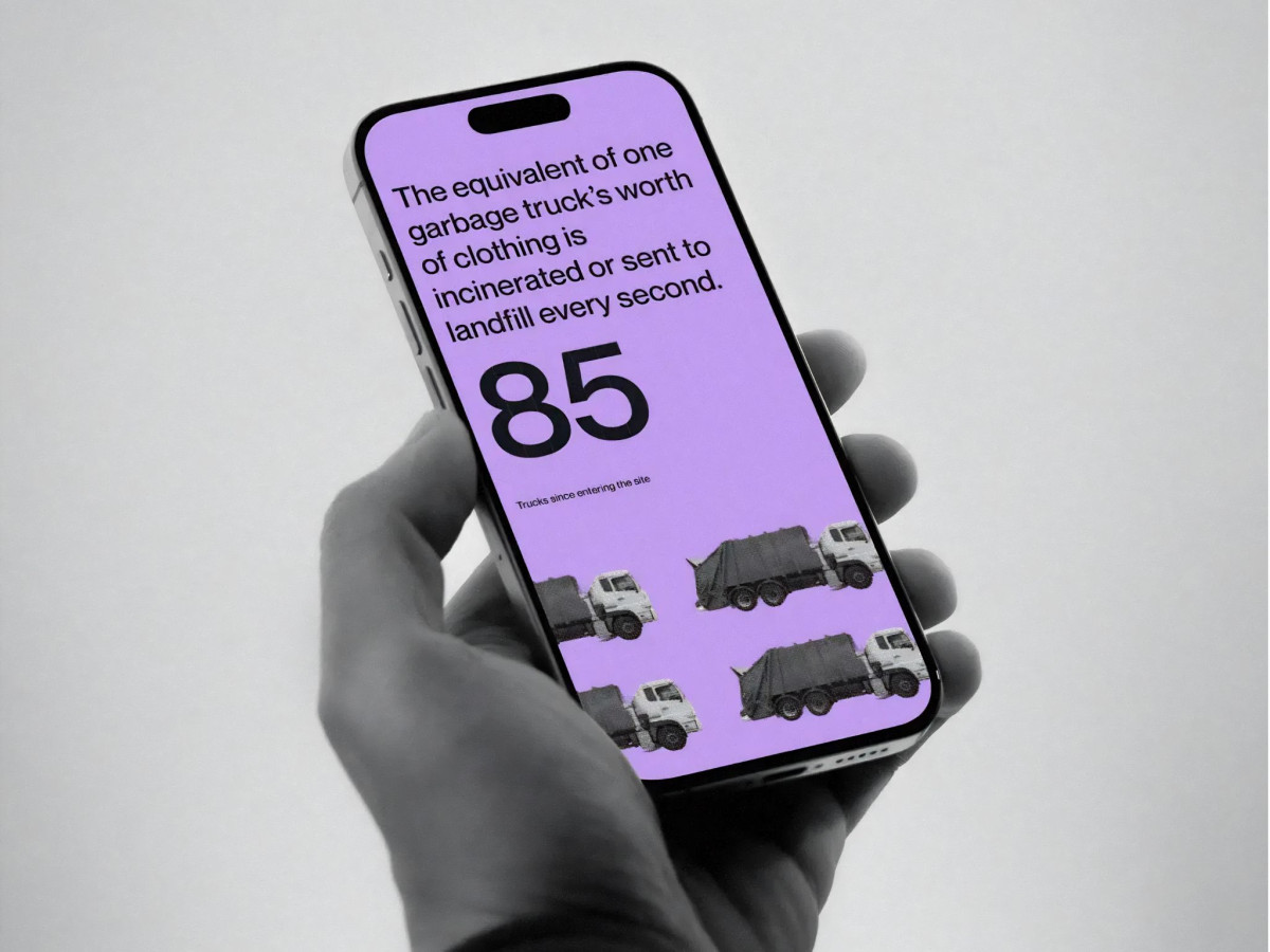 Hand holding phone showing fast fashion clothing waste statistics.