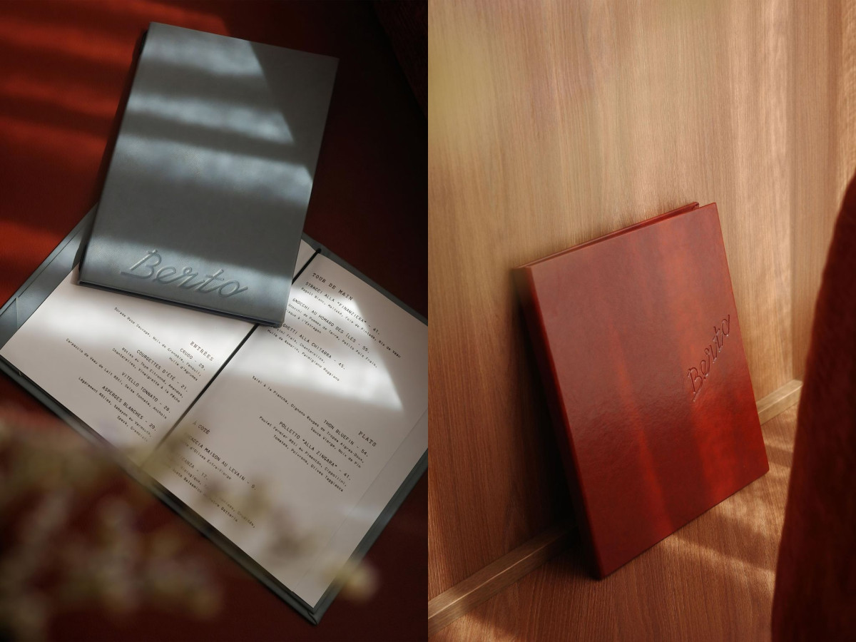 Grey and red Berto restaurant menus in natural sunlight.
