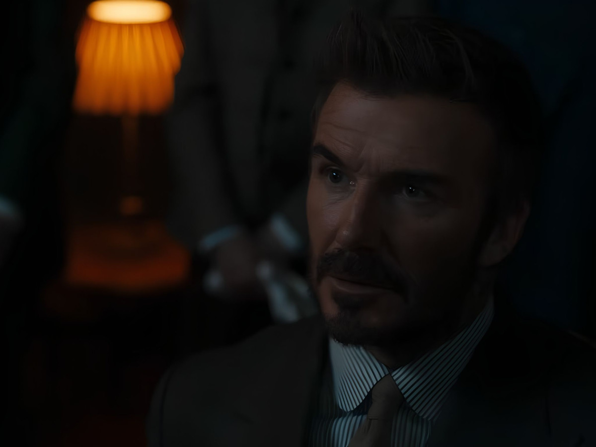 David Beckham looking focused in moody, atmospheric lighting.