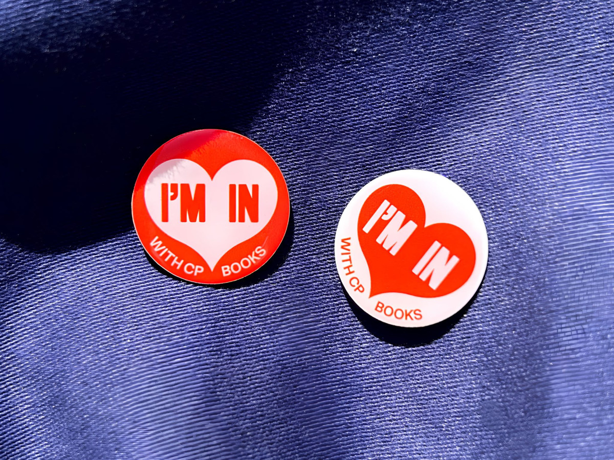 Two round badges reading "I'm in with CP Books."