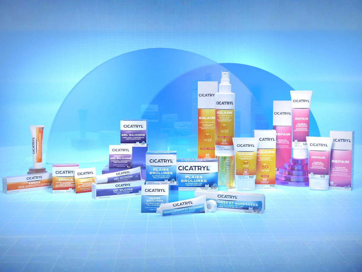 The complete Cicatryl line, unified by a shared white-cap-and-bilingual-name architecture but color-coded by function — blue for wound care, orange for arnica, yellow for sun protection, purple for scar gel, and pink for barrier repair.