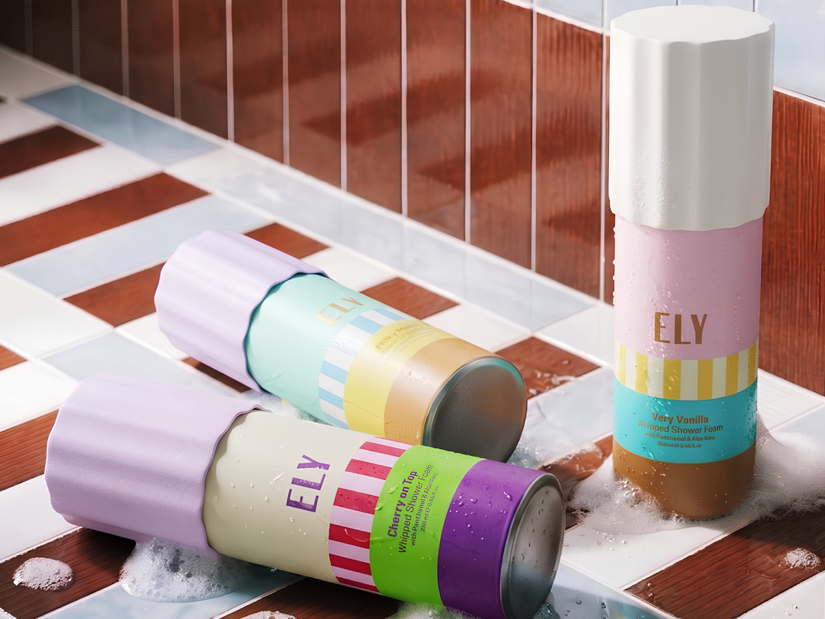 Three Ely shower foam bottles resting on a tiled surface.