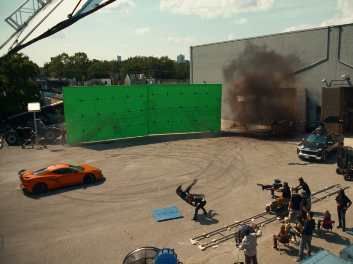 Orange Chevy filming on a green screen set.
