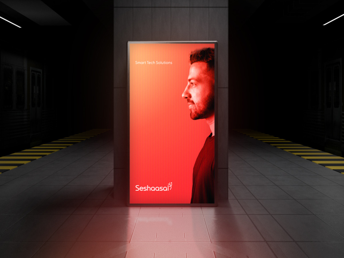 Red illuminated Seshaasai billboard featuring a man's profile.