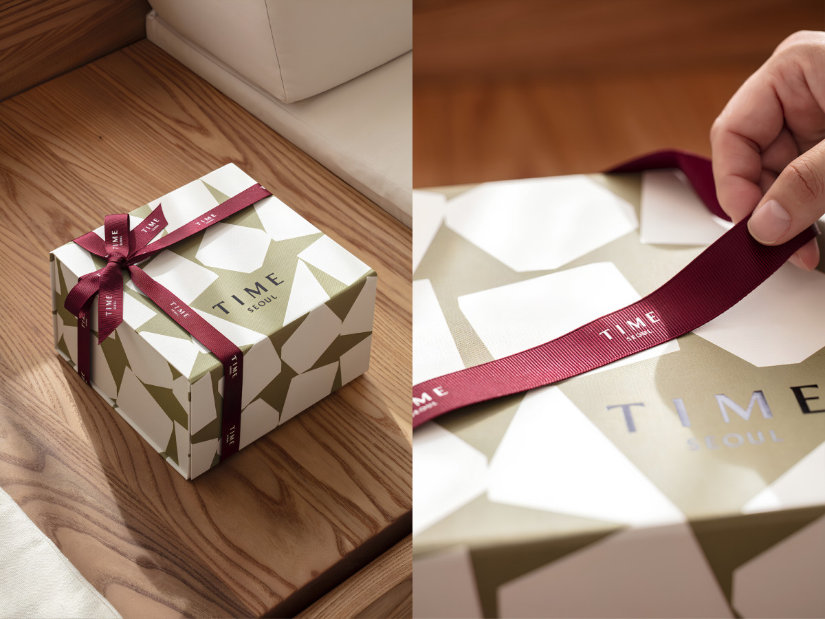 TIME SEOUL patterned gift box wrapped with burgundy ribbon.