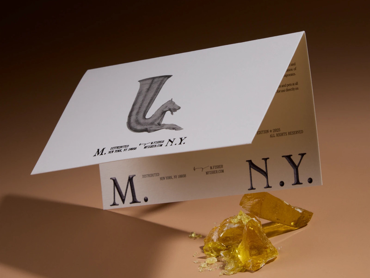 Demeter card with abstract logo and yellow resin fragments.