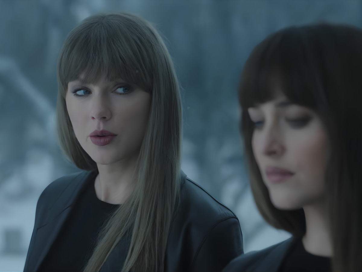 Taylor Swift and another woman standing in snow.