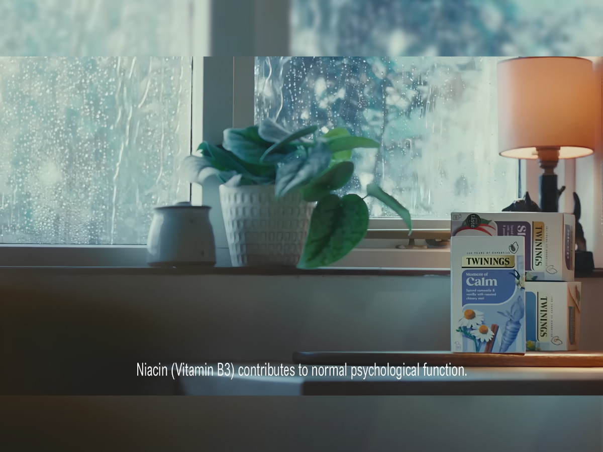 Twinings tea boxes on a windowsill during rain.