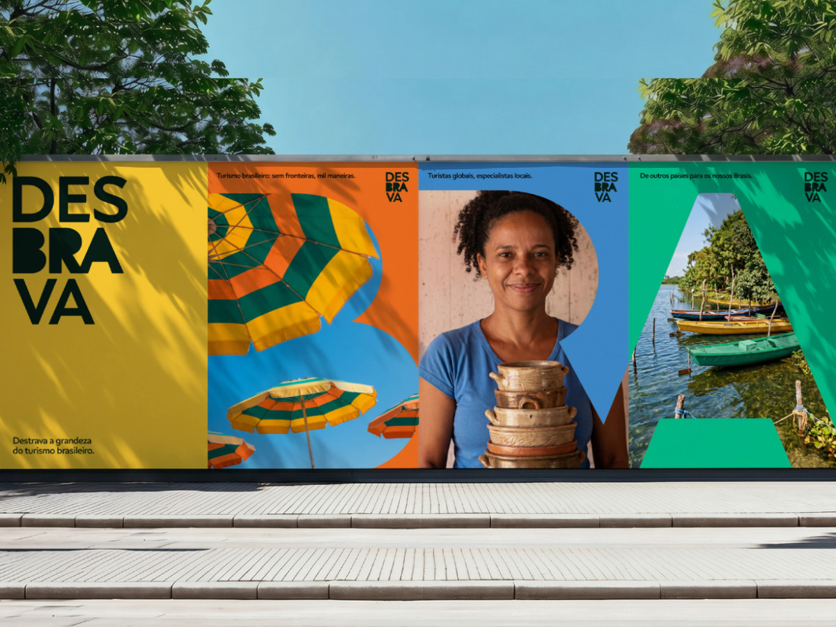 Colorful Desbrava outdoor billboard featuring photography inside large letters.