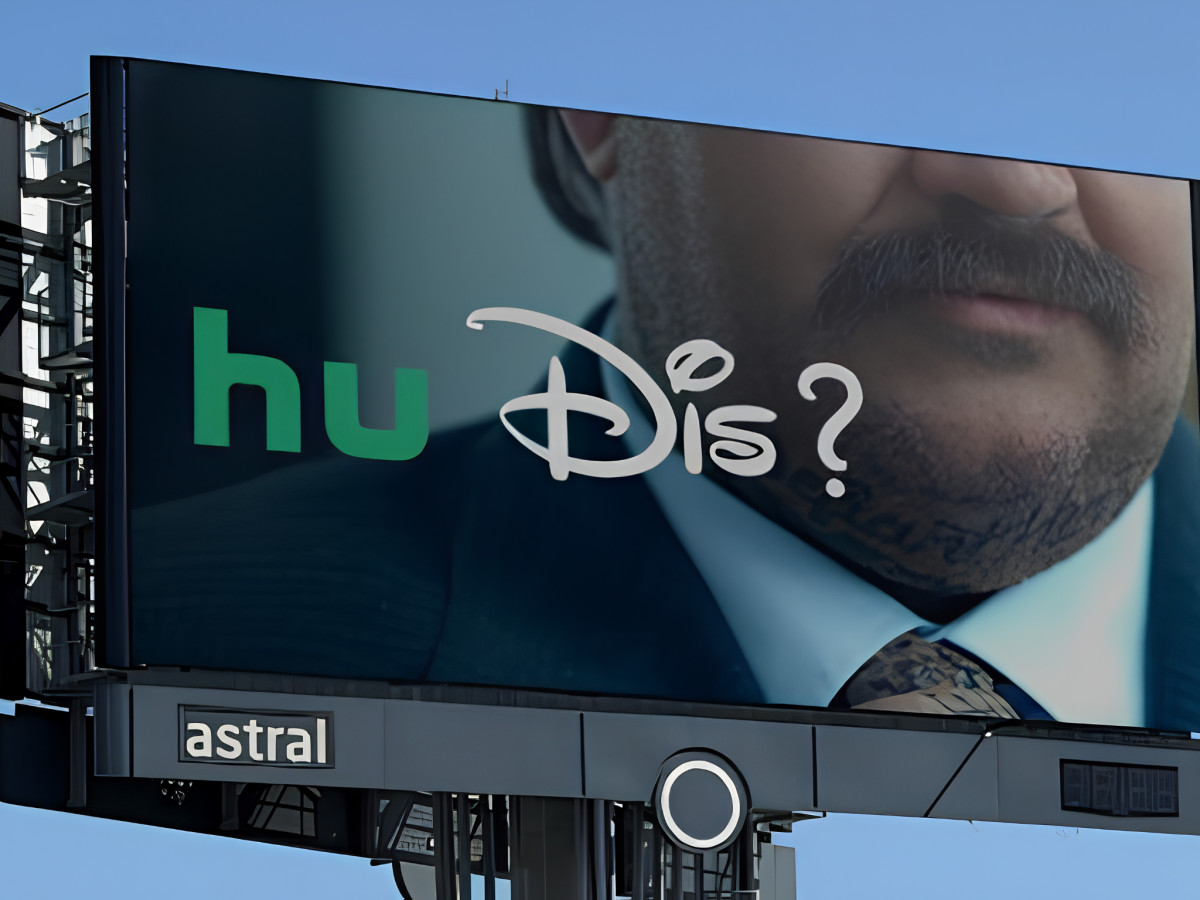 "Hu Dis?" billboard featuring a cropped character portrait.