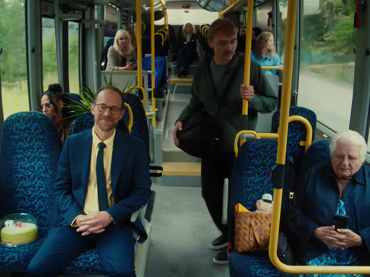 Man sitting on a public bus maintaining personal space.