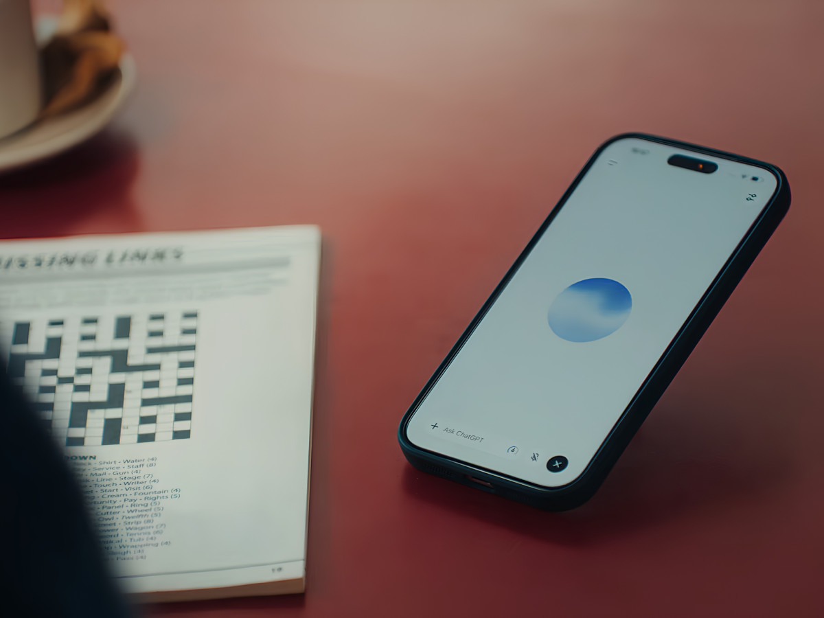 Smartphone displaying active ChatGPT Voice interface on table.