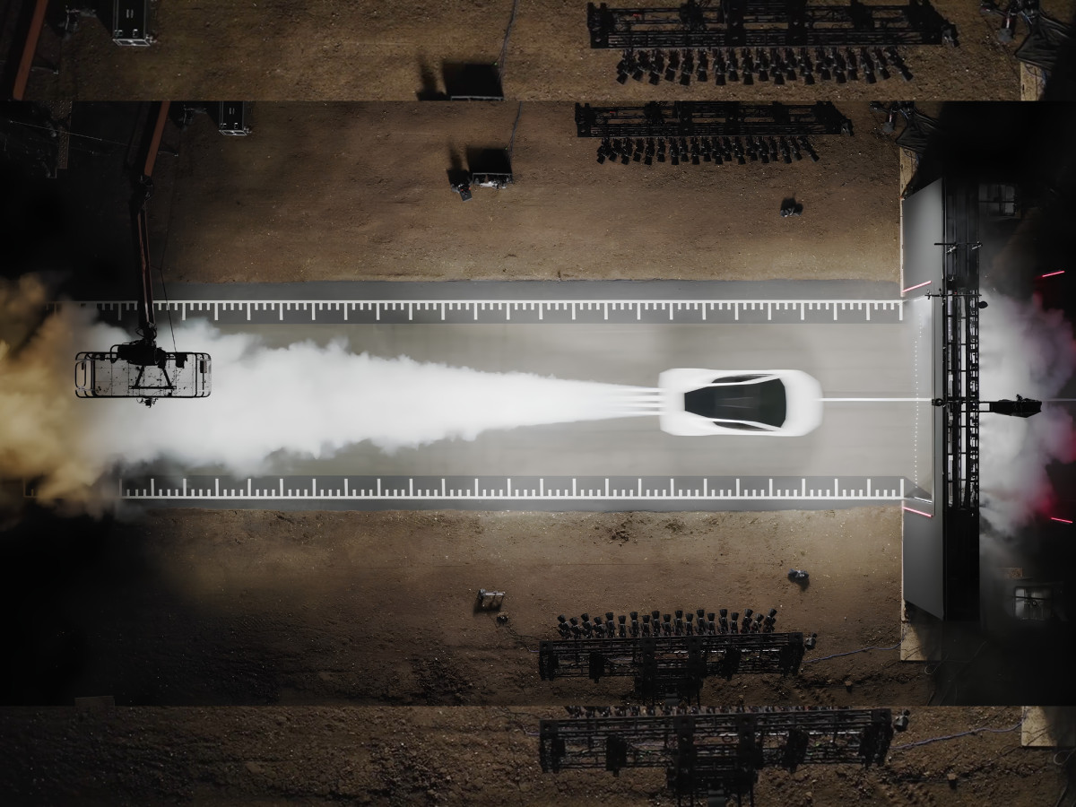 Overhead view of sports car accelerating with smoke trail.