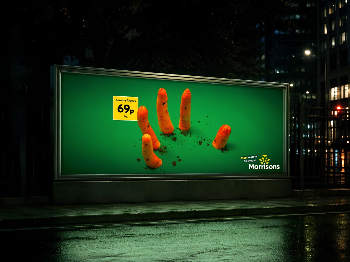 Morrisons billboard featuring carrots arranged like zombie fingers.