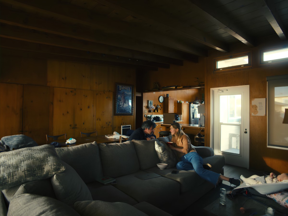 Nathan Fielder and Elizabeth Holmes sitting in living room.