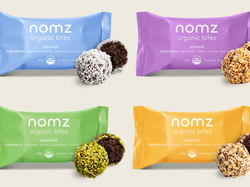 Nomz organic bites packaging in four colorful wrappers by Olivia Springle.