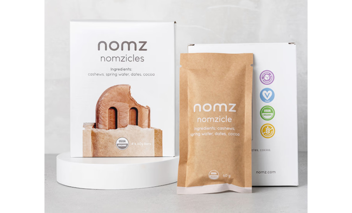 Nomz Nomzicles packaging featuring product box with ingredients and individual pouch by Olivia Springle.