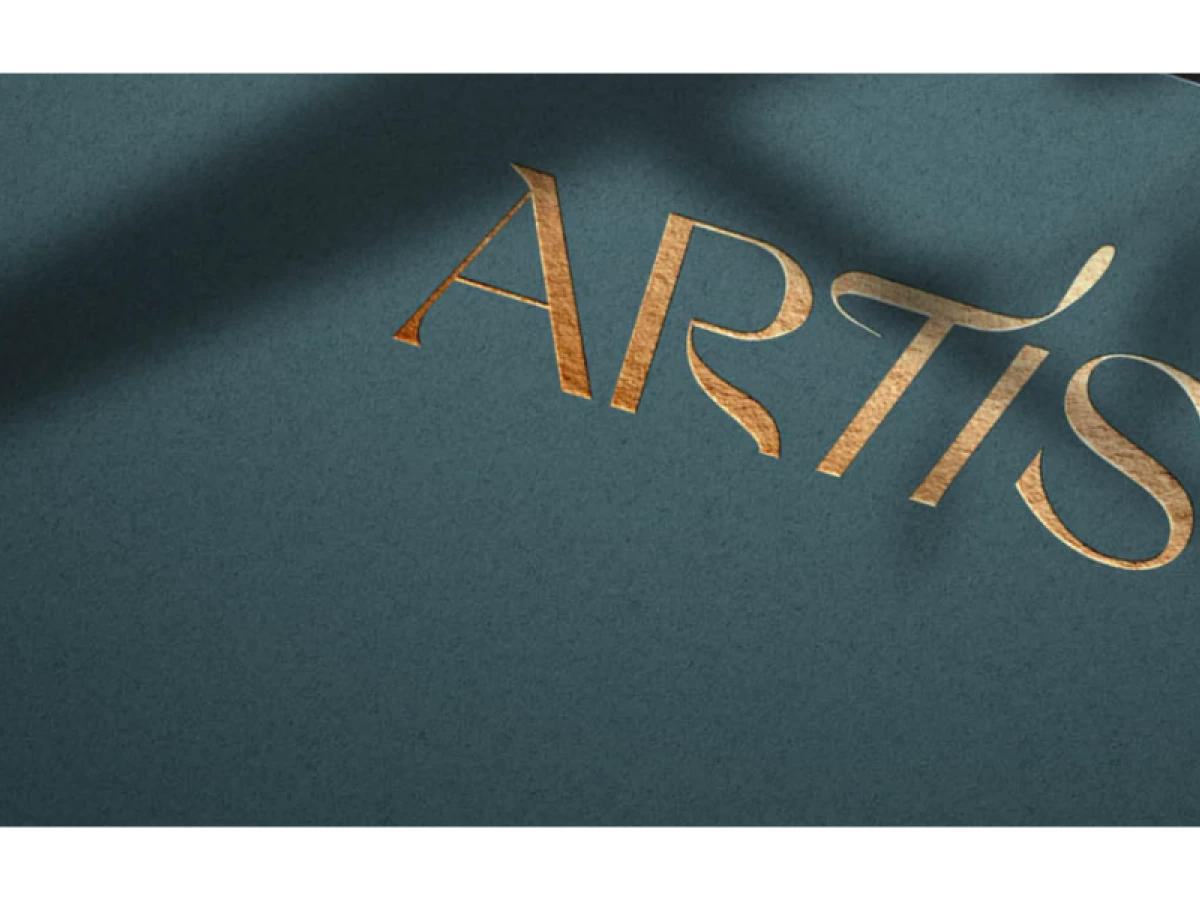 Artis logo in gold foil on textured teal paper by Noyk.