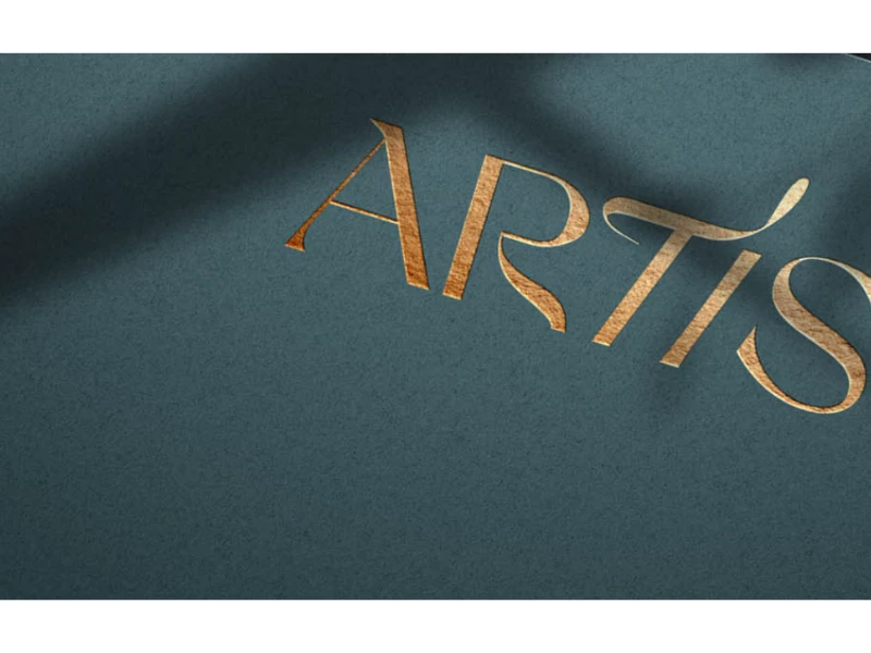 Artis logo in gold foil on textured teal paper by Noyk.