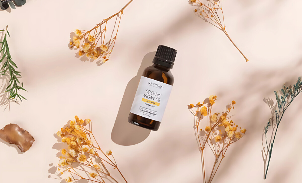 Fiore Argan oil dropper bottle surrounded by natural dried flowers.
