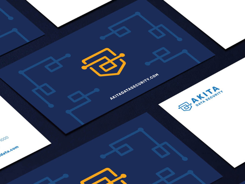 Business cards for Akita Data Security with circuit-style shield logo.