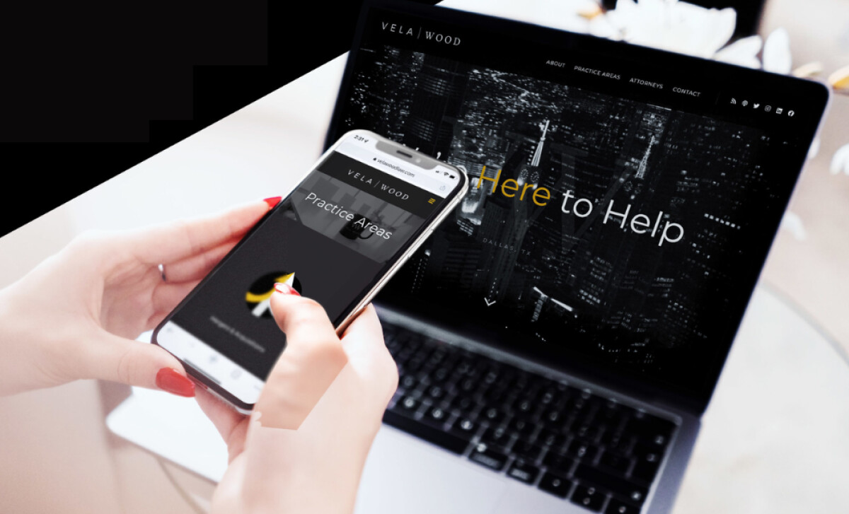 Vela Wood law firm website displayed on mobile and laptop.