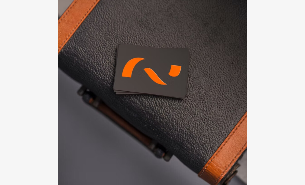 MadLow Studio business card's abstract orange logo on a black background